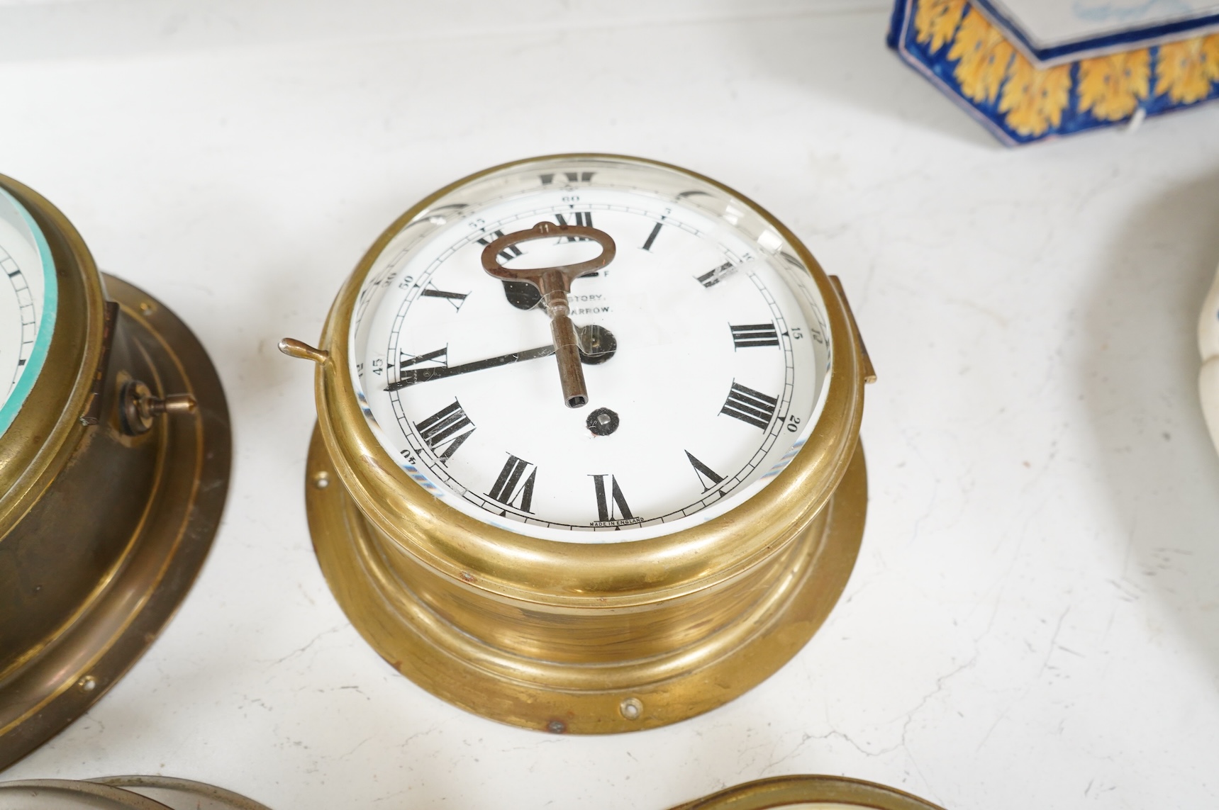 A ship's clock by Story of Barrow, a CCCP ship's clock and four other brass examples, some with keys, largest 28cm in diameter